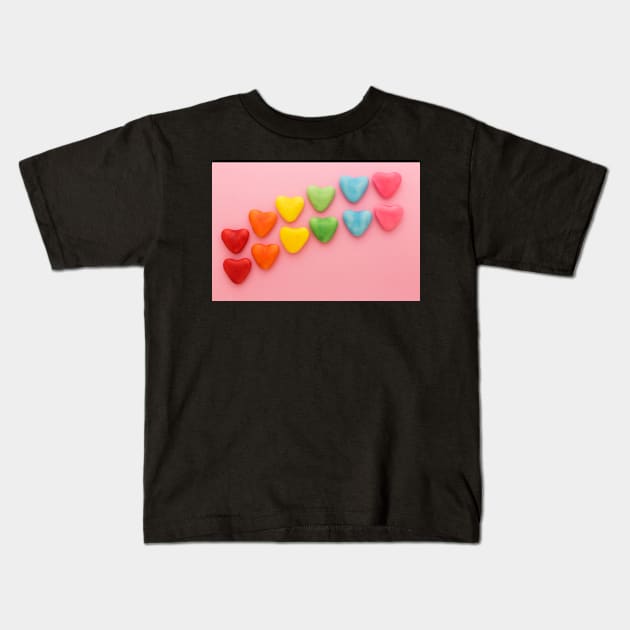 Heart-shaped Candy arranged in rainbow order on a pink background Kids T-Shirt by karinelizabeth